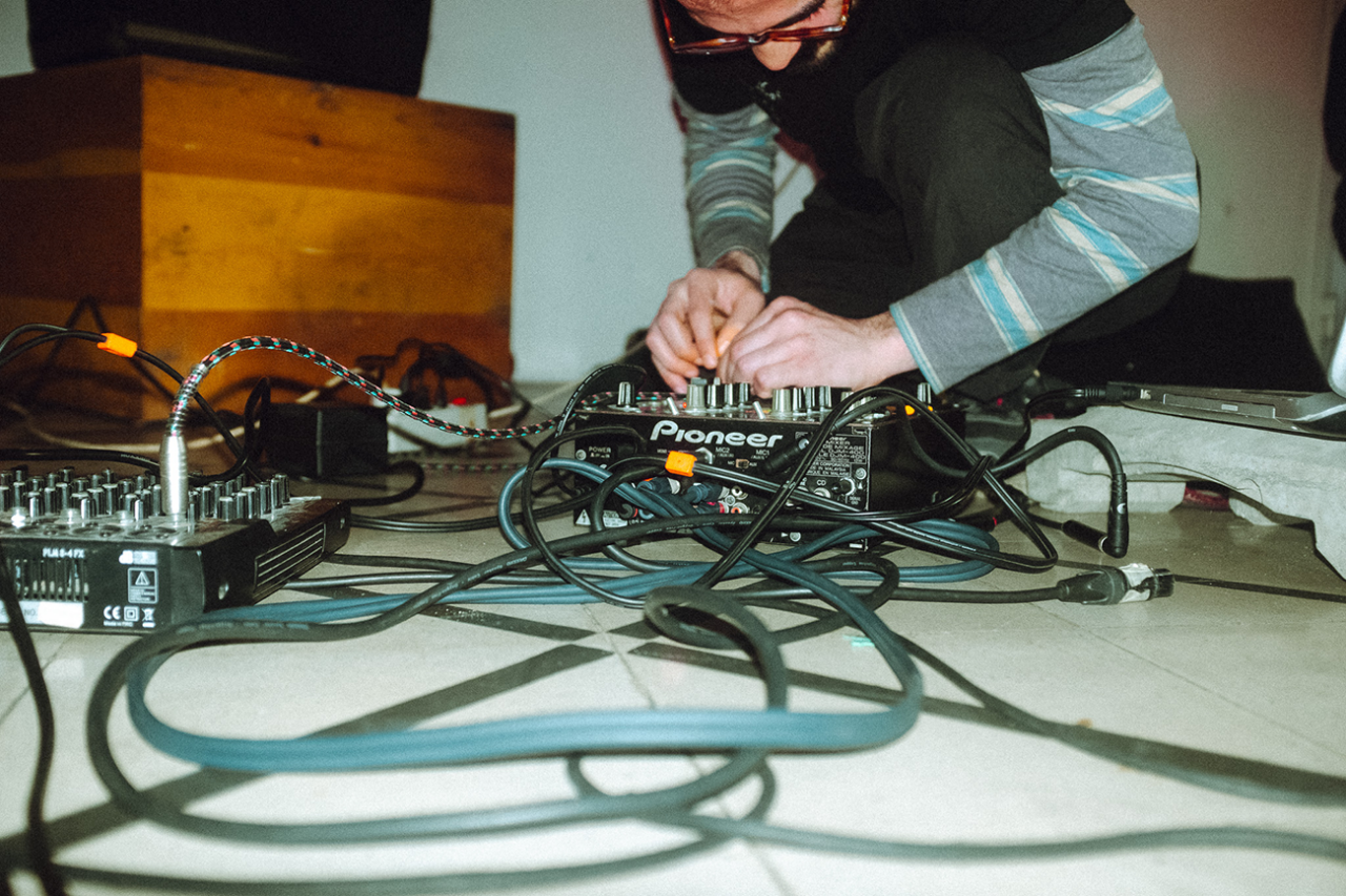 Person handling cables of a sound device.